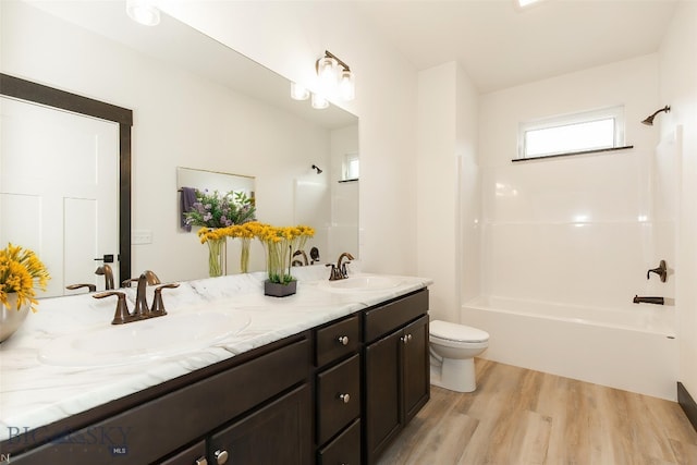 1511 Pistolero Way, Belgrade, MT 59714 - full bath with wood finished floors, toilet, shower / bath combination, and double vanity