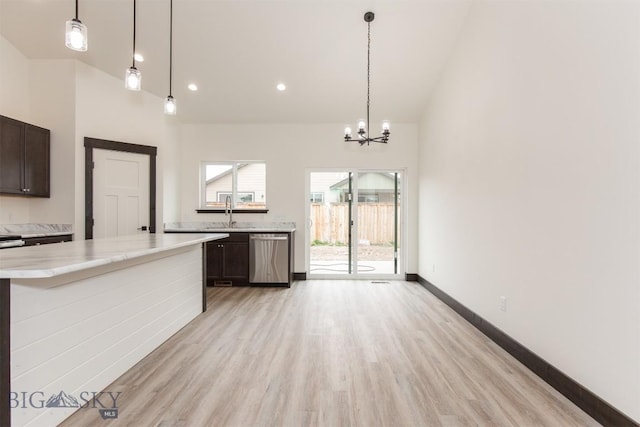 1511 Pistolero Way, Belgrade, MT 59714 - kitchen with dishwasher, light wood-style flooring, a chandelier, dark brown cabinets, and decorative light fixtures