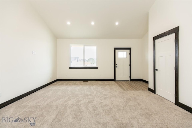 1511 Pistolero Way, Belgrade, MT 59714 - spare room featuring vaulted ceiling, light colored carpet, recessed lighting, and baseboards