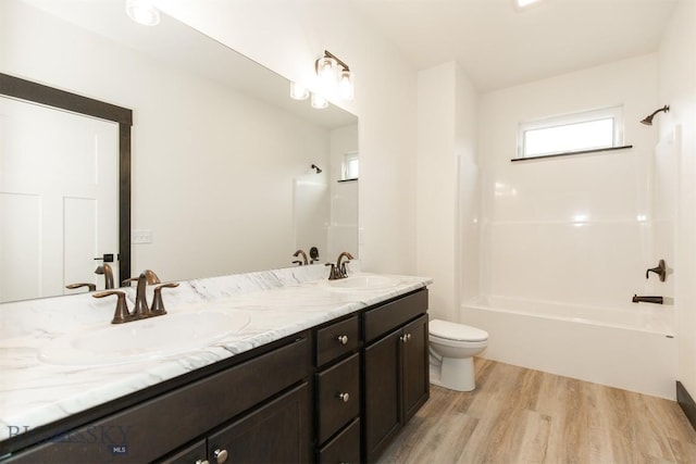 1511 Pistolero Way, Belgrade, MT 59714 - bathroom with wood finished floors, washtub / shower combination, toilet, and double vanity