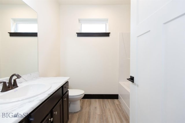 1511 Pistolero Way, Belgrade, MT 59714 - bathroom featuring wood finished floors, vanity, toilet, a bath, and a shower