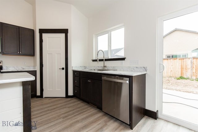 1511 Pistolero Way, Belgrade, MT 59714 - kitchen with stainless steel dishwasher, a sink, light wood-style flooring, and light countertops