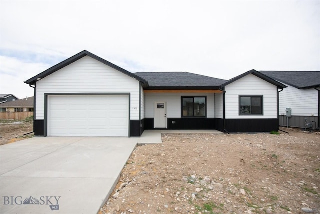1511 Pistolero Way, Belgrade, MT 59714 - view of front facade with concrete driveway and a garage
