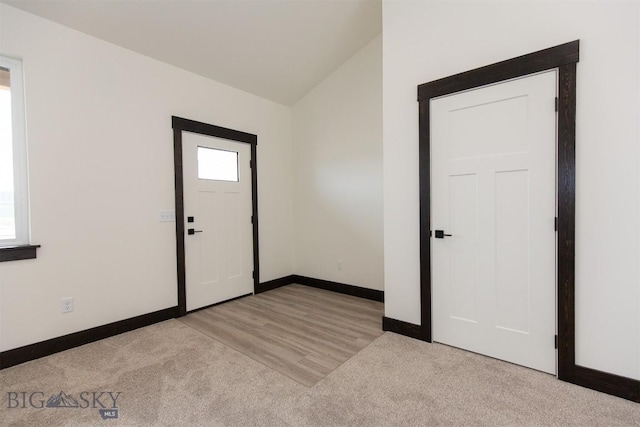 1511 Pistolero Way, Belgrade, MT 59714 - foyer with baseboards, carpet flooring, and vaulted ceiling