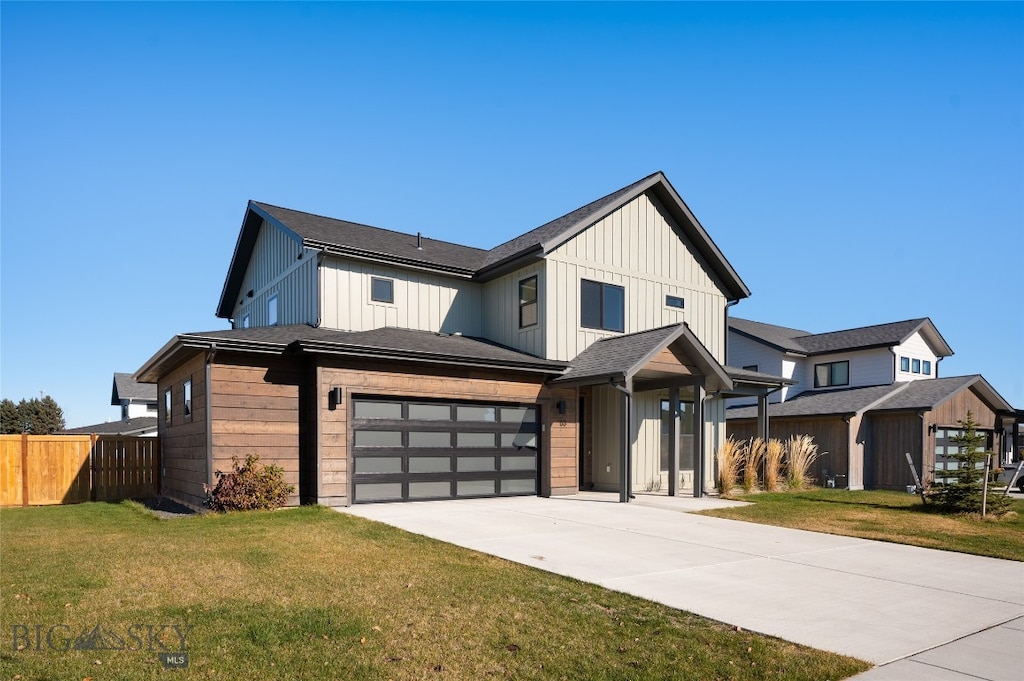 modern inspired farmhouse with a garage and a front yard