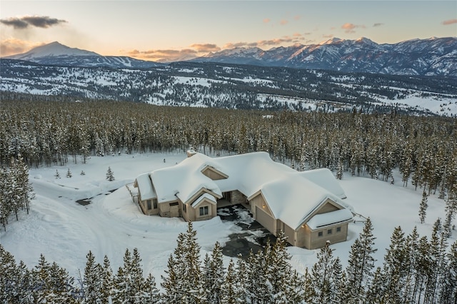 snowy aerial view with a mountain view