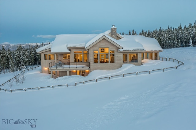 view of snow covered back of property