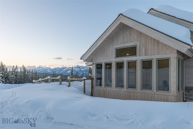 view of snow covered exterior featuring a mountain view