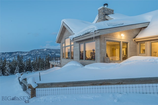 snow covered property with a mountain view