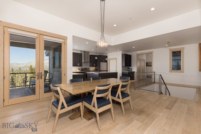 dining room featuring french doors, a mountain view, and light hardwood / wood-style flooring