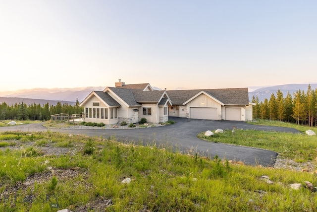 view of front facade featuring a garage and a mountain view