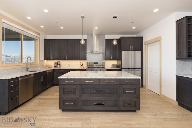 kitchen with dark brown cabinetry, wall chimney exhaust hood, and appliances with stainless steel finishes