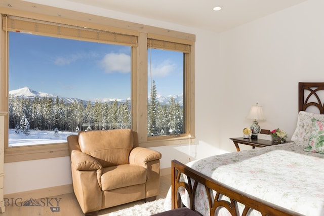 bedroom featuring a mountain view and multiple windows