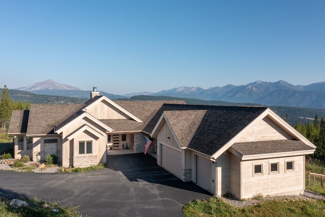 view of front of home with a garage and a mountain view