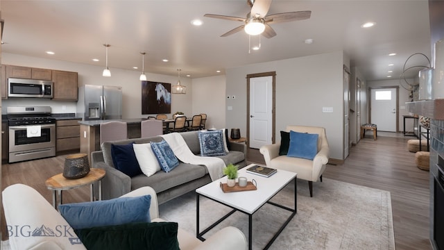 living room featuring light wood-type flooring and ceiling fan