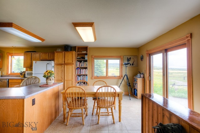 dining area featuring light tile patterned flooring