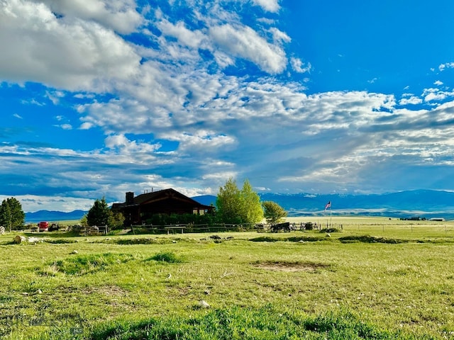 view of yard featuring a rural view and a mountain view