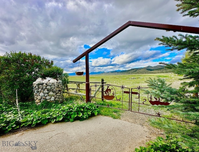 view of patio / terrace featuring a mountain view and a rural view