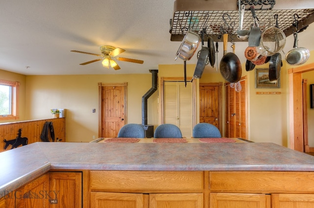 kitchen featuring a textured ceiling and ceiling fan