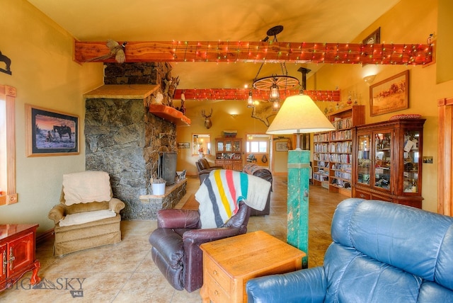 living room featuring a towering ceiling, a stone fireplace, and tile patterned flooring