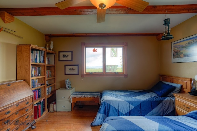 bedroom featuring light hardwood / wood-style floors, ceiling fan, and beam ceiling