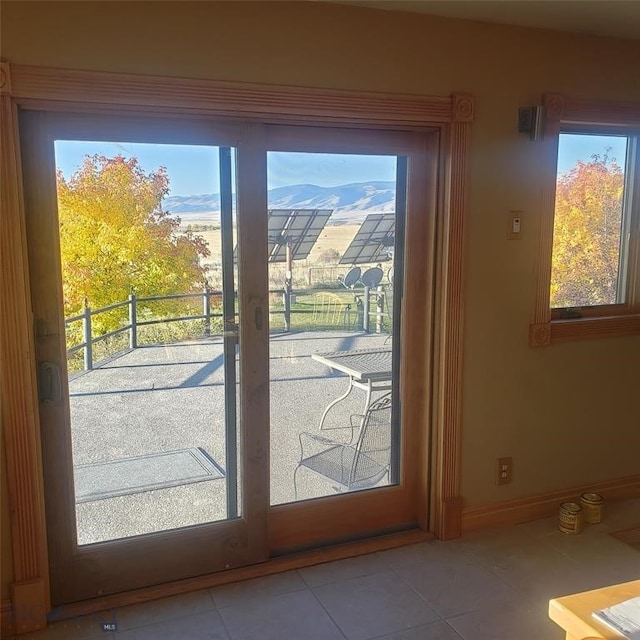 entryway featuring a mountain view and light tile patterned floors