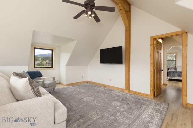 living room featuring hardwood / wood-style flooring, ceiling fan, plenty of natural light, and vaulted ceiling