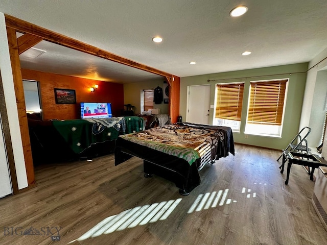 bedroom featuring hardwood / wood-style floors and a textured ceiling