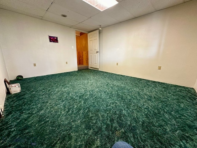 empty room featuring a drop ceiling and carpet floors