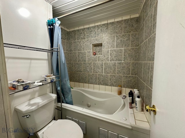 bathroom featuring toilet and shower / bath combination with curtain