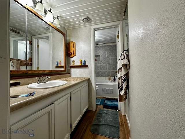 full bathroom with hardwood / wood-style floors, vanity, shower / bath combination with curtain, and toilet