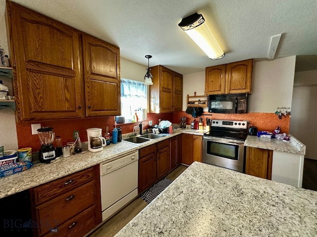 kitchen with decorative light fixtures, sink, hardwood / wood-style flooring, electric range, and dishwasher