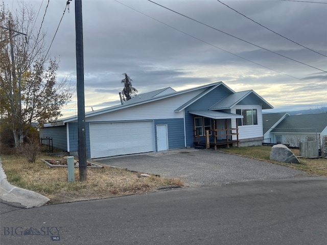 ranch-style house featuring a garage and covered porch