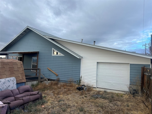 back of property featuring a garage