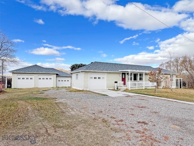 ranch-style home with a garage, a front yard, and covered porch