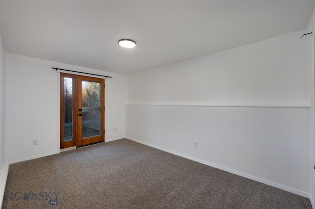 carpeted empty room featuring french doors