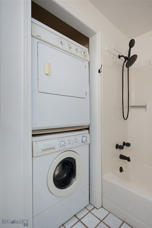 washroom with stacked washer and dryer and light tile patterned floors