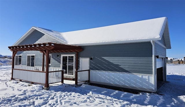 view of front of home featuring a garage and a pergola