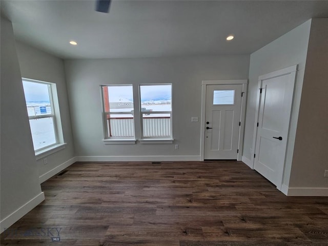 foyer with dark wood-style floors, baseboards, and recessed lighting