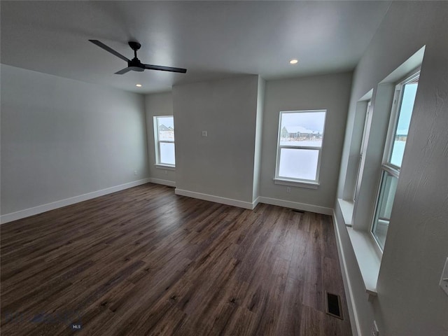 spare room featuring baseboards, visible vents, dark wood-type flooring, and recessed lighting