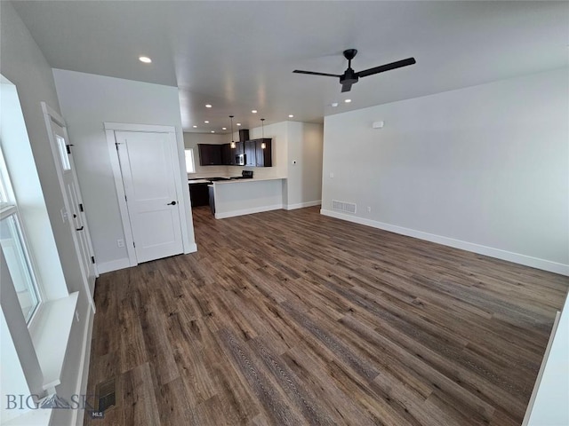 unfurnished living room featuring dark wood-style floors, recessed lighting, visible vents, and baseboards