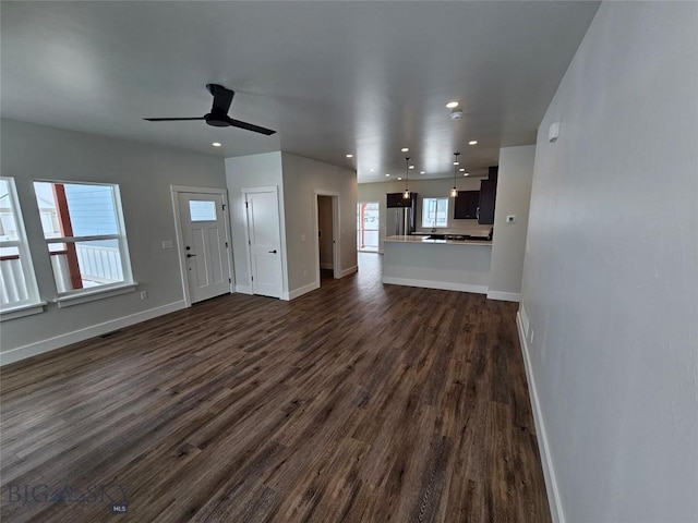 unfurnished living room with dark wood-style floors, recessed lighting, ceiling fan, and baseboards