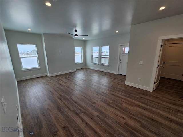 unfurnished living room featuring recessed lighting, dark wood-style flooring, ceiling fan, and baseboards