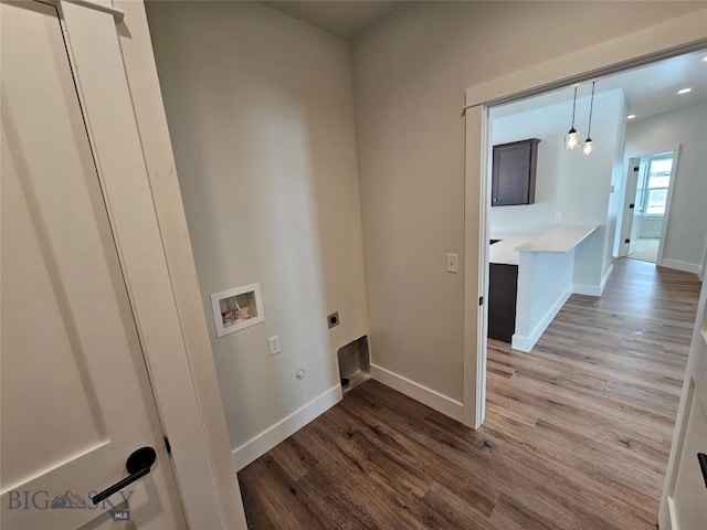 laundry room with laundry area, baseboards, wood finished floors, hookup for a washing machine, and electric dryer hookup