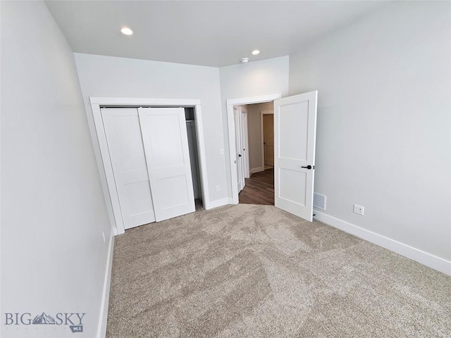 unfurnished bedroom featuring recessed lighting, a closet, visible vents, carpet flooring, and baseboards