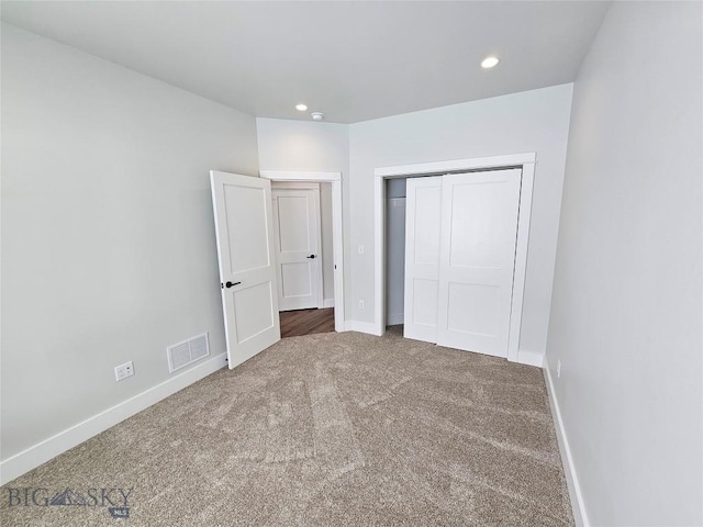 unfurnished bedroom with recessed lighting, carpet flooring, visible vents, and baseboards