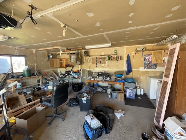 interior space featuring washer / clothes dryer, a garage door opener, and a workshop area