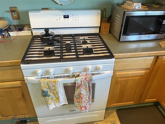 interior details featuring white range with gas cooktop