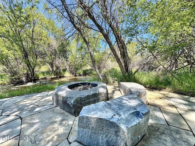 401 Mill Crk, Sheridan, MT 59749 - view of patio featuring an outdoor fire pit