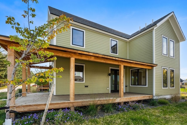 rear view of property featuring a wooden deck